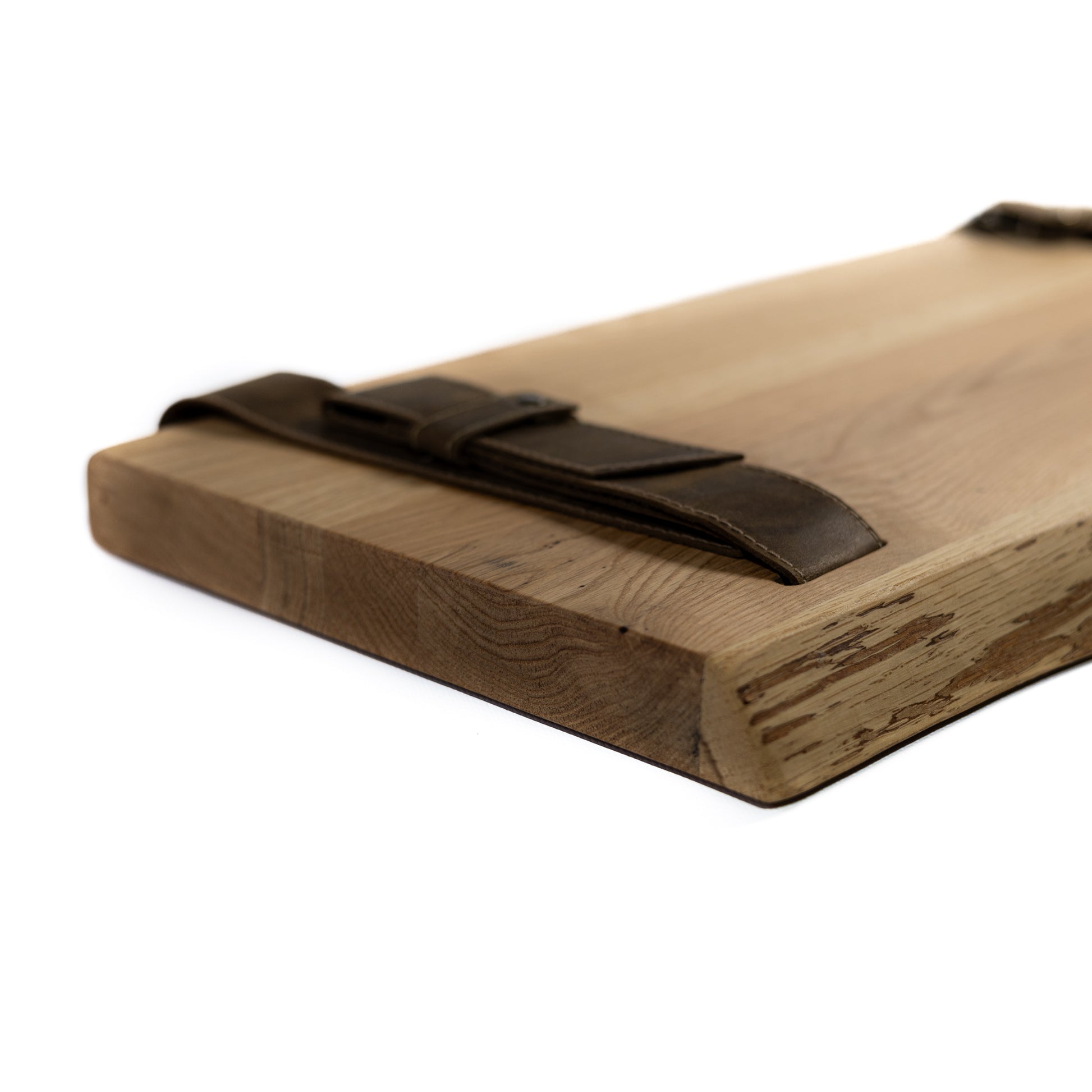Close-up of natural oak wood grain and brown leather straps with metal fittings