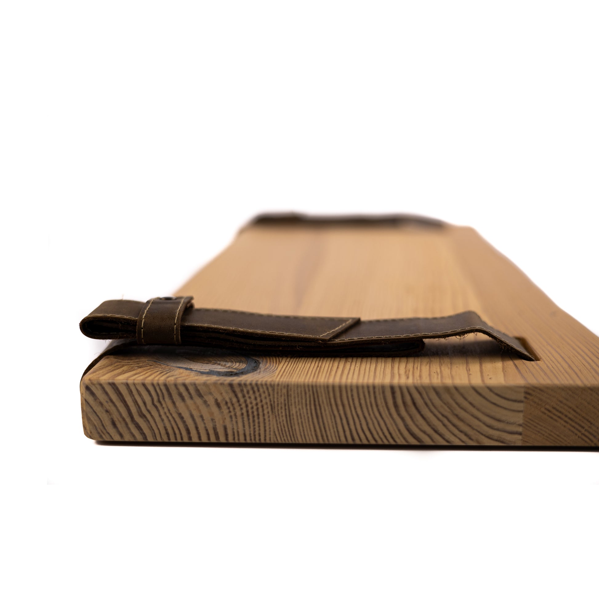 Wooden pine shelf with a leather strap on a white background