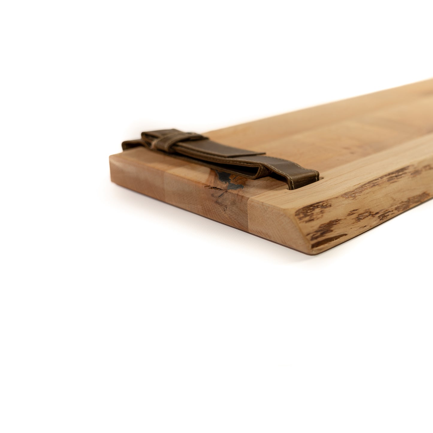 Close-up of red pine wood grain and brown leather straps